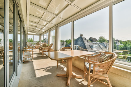 brick balcony with metal railings, wooden chair and door with glass leads to the kitchenの写真素材