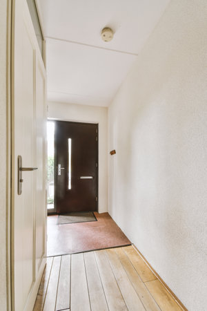 Corridor of contemporary apartment with and doorway leading to terraceの写真素材