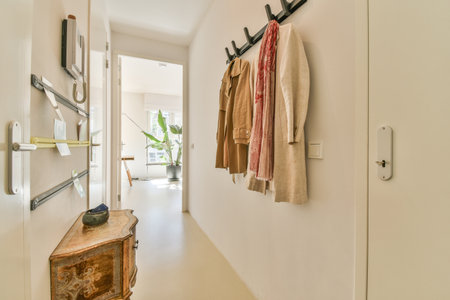 Interior of minimalist style narrow hallway with wall hanger and cabinet in modern apartmentの写真素材