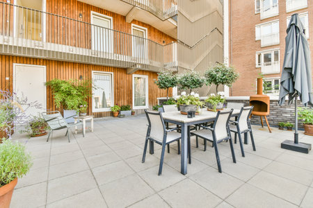 Panorama view of brick houses from an empty sidewalk street with treesの写真素材