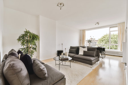 Contemporary minimalist style interior design of light studio apartment with wooden table and chairs...