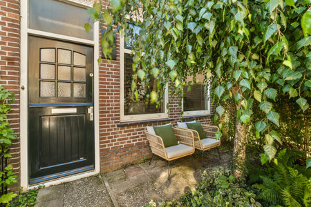 Neat powerful patio with sitting area and small garden near wooden fence