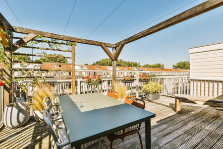 Bright brick balcony with metal railings, wooden chair and door