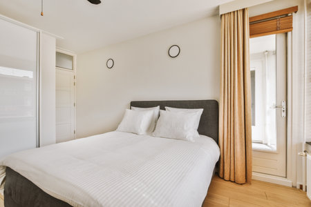 Home interior design of bedroom with bed and wooden wardrobe placed in corner near window in modern...
