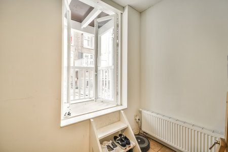 Sofa located near lounge area and open kitchen in spacious room of contemporary apartment