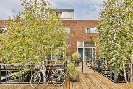 Panorama view of brick houses from an empty sidewalk street with trees and lanterns