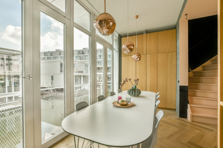 Couches and table located near TV against dining area of spacious room in contemporary apartment