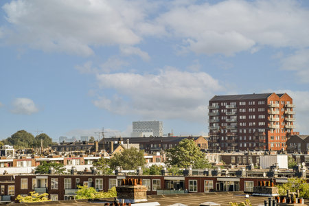 Panoramic view of brick buildings trees from small balcony