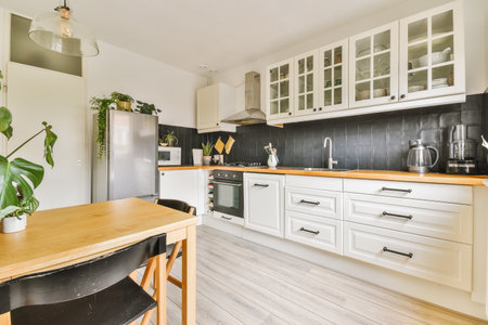 a kitchen with white cabinets and wood counter tops on the island in front of the sink is wooden...