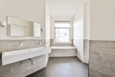 a bathroom with two sinks and a mirror on the wall, in front of a large white bathtub next to a...