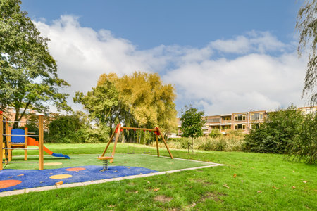 an outdoor play area with swings, slides and climbing equipment in the background is a blue sky...
