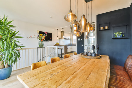 a dining room with a wooden table and some plants in pots on the wall next to the kitchen is dark...