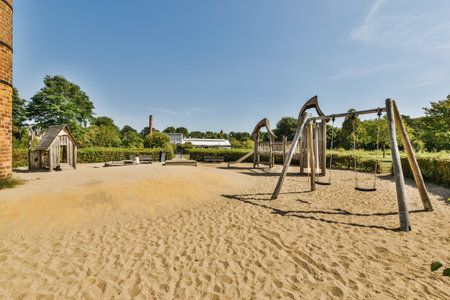 an empty playground with swings and slides in the middle part of the park, surrounded by trees and...