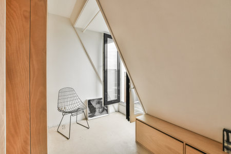 a room with a chair in it and an open door leading to the balcony area on the other side of the room