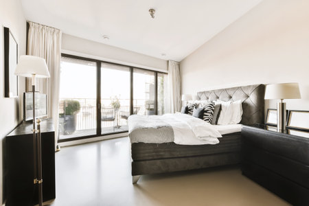 a bedroom with a large bed and sliding glass doors that open onto the balcony overlooking pool area...