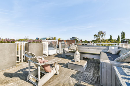 a roof with some furniture on it and the sky in the back ground is bright blue, but no clouds are visibleの写真素材