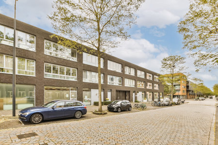 a city street with cars parked on the side and buildings in the back ground, all lined up to the...