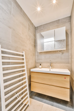 a modern bathroom with grey tiles and white fixtures on the walls, along with a towel rack in the...