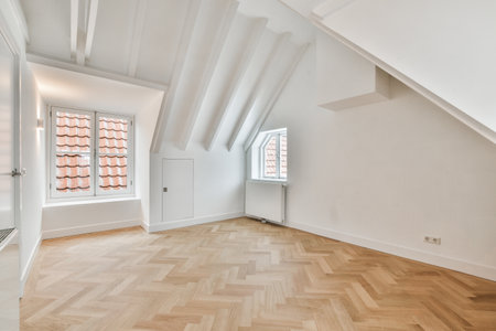 an empty room with wood flooring and white walls in the center of the room is a window that looks...