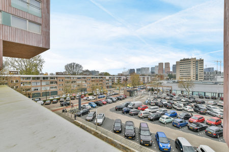 a parking lot with cars parked in it and buildings on the other side of the street, as seen from aboveのeditorial素材