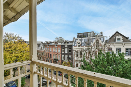a balcony with trees and buildings in the background, taken from an apartment window looking out to the street belowのeditorial素材
