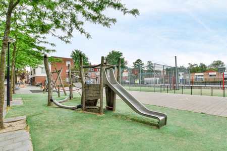 Amsterdam, Netherlands - 10 April, 2021: an empty playground with a slide in the middle schools childrens play area, which has been closed since since sinceのeditorial素材
