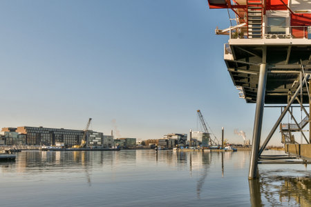 a boat in the water with buildings in the background and blue sky overcasted by some boats on the waterの写真素材