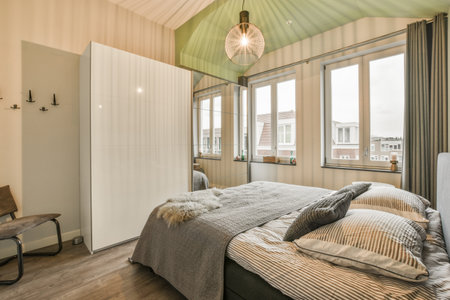 a bedroom with green walls and white trim on the ceiling, there is a bed in front of the window