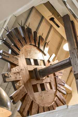 a clock made out of wood planks in a room with no one on the wall or ceiling, as seen from aboveの写真素材