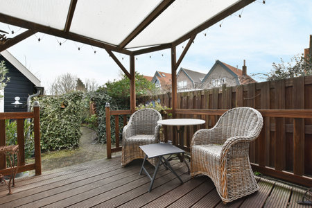 an outside area with chairs and tables under a white awning on a wooden deck in the photo is taken...