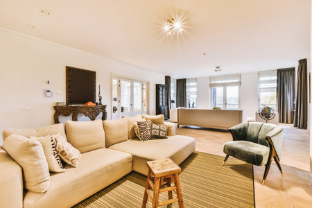 a living room with couches, chairs and a coffee table in the middle part of the room is whiteの写真素材