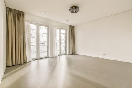 an empty living room with sliding glass doors and floor to the right, there is no one person in it