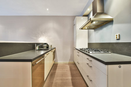 a modern kitchen with black counter tops and white cabinets in the room is lit by light coming from...