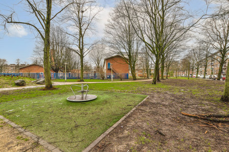 an empty playground in the middle of a residential area, with no people or children playing on the...