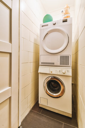 a laundry room with a washer and dryer next to the door that has been installed on the wallの写真素材