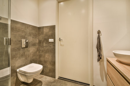 a bathroom with a toilet, sink and shower stall in the same room on the other side of the wall