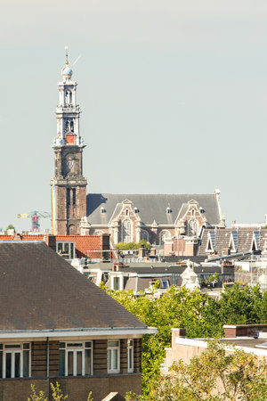a city with buildings and a clock tower in the middle part of the photo, taken from my bedroom windowのeditorial素材
