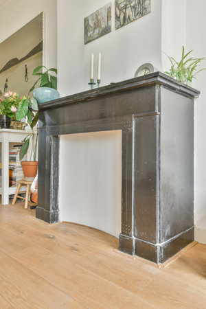 Amsterdam, Netherlands - 10 April, 2021: a living room with wood flooring and white walls in the center of the room is a black console tableのeditorial素材