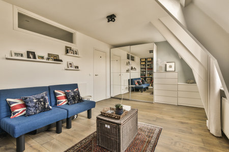a living room with two couches and a coffee table on the floor in front of an attic style home