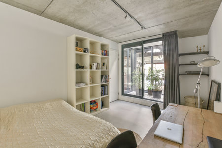 a bedroom with a bed, desk and bookcases in the room is very neat clean white paint on the walls