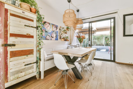 Amsterdam, Netherlands - 10 April, 2021: a kitchen and dining area in a house with wood floors, white walls, wooden flooring and an open door leading to theのeditorial素材