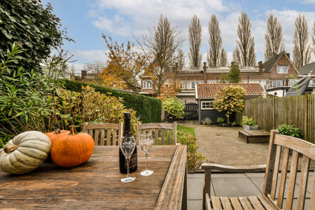 Amsterdam, Netherlands - 10 April, 2021: a table outside with some pumpkins on it and a bottle of...