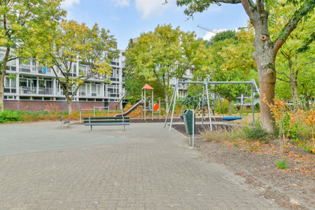 Amsterdam, Netherlands - 10 April, 2021: a playground in the middle of an apartment complex with...