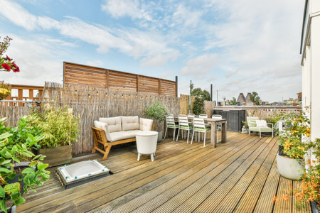 Amsterdam, Netherlands - 10 April, 2021: a deck with chairs, tables and plants in the fore - eyed view on a cloudy blue sky above itのeditorial素材