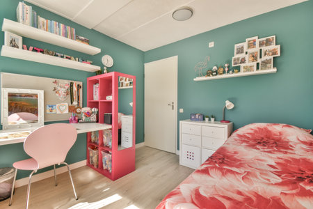 Amsterdam, Netherlands - 10 April, 2021: a girls bedroom with blue walls and white trim on the ceiling, shelvings her pink bedのeditorial素材