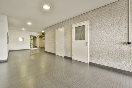 an empty room with white bricks on the wall and doors to the other rooms in the room is very clean
