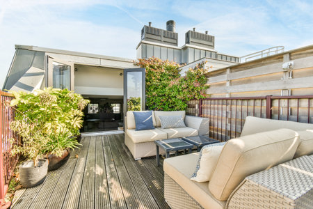 Amsterdam, Netherlands - 10 April, 2021: an outdoor living area with couches, chairs and plants on...