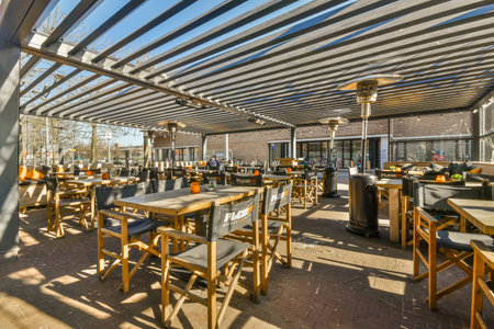 an outdoor dining area with tables and chairs under a canopy that covers the restaurants aws, which can be used forのeditorial素材
