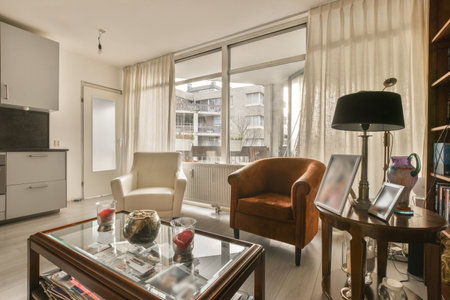 Amsterdam, Netherlands - 10 April, 2021: a living room with two chairs and a coffee table in the photo is taken from an outside window looking out onto the streetのeditorial素材