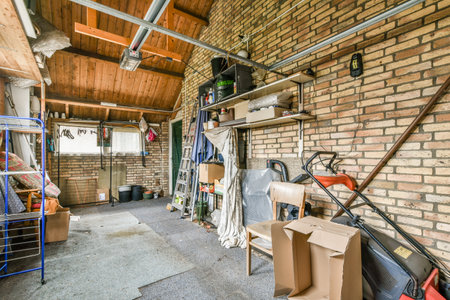 a garage with boxes, tools and other things on the floor in front of the garage is full of stuffのeditorial素材
